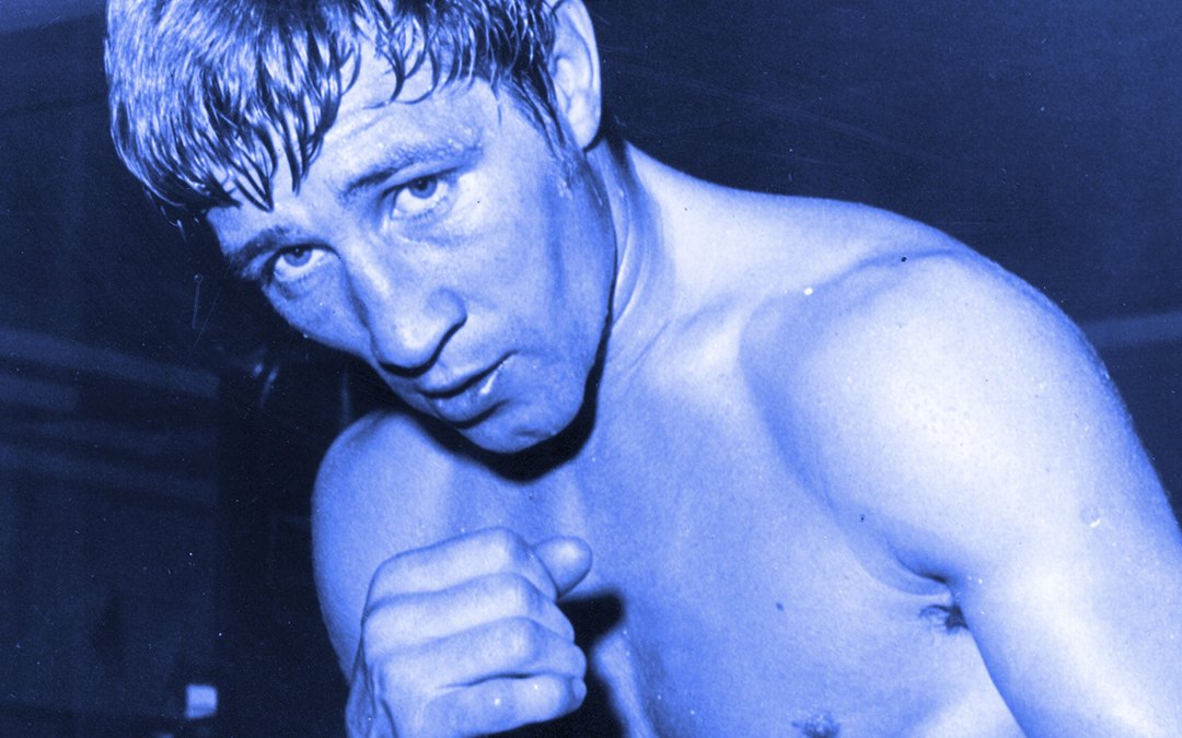 Archive photograph of the boxer Ken Buchanan with his guard up, tinted blue