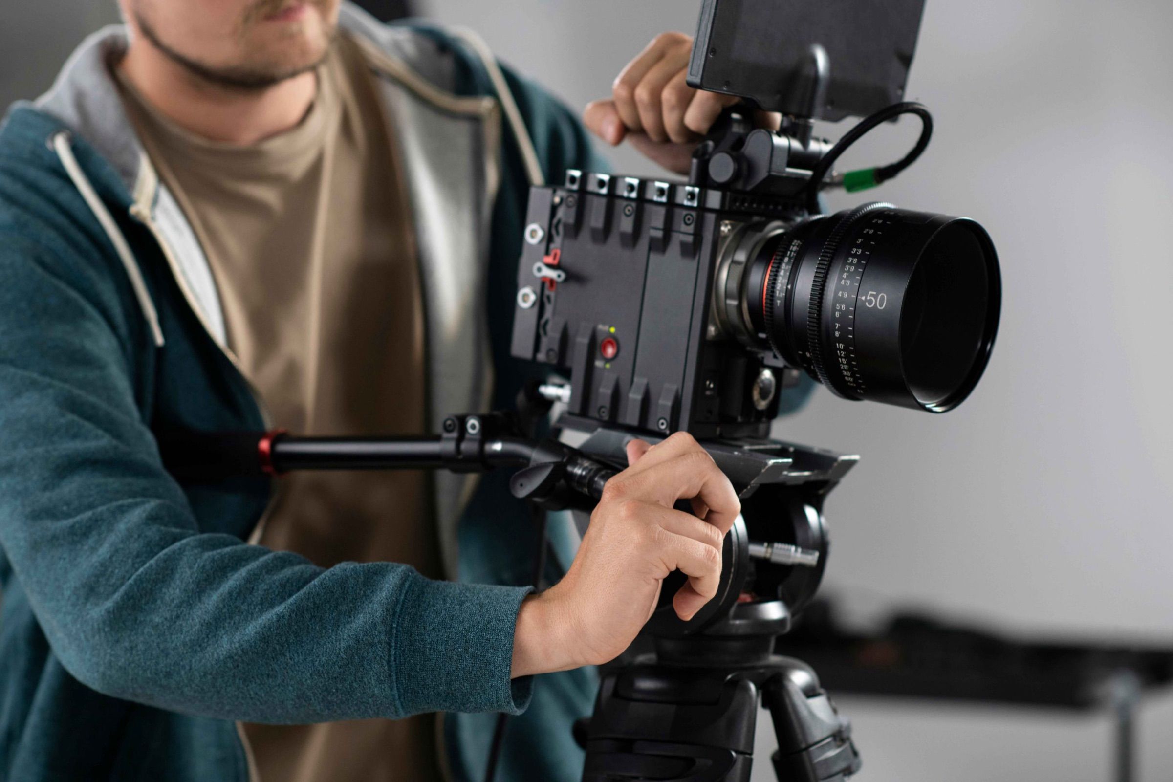 A camera operator filming with a professional cinema camera